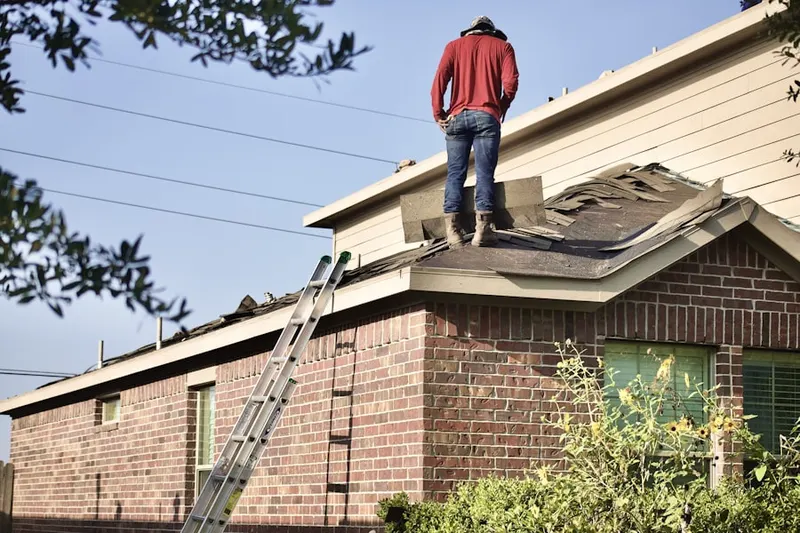 Professional roofer working on a residential roof in Conway